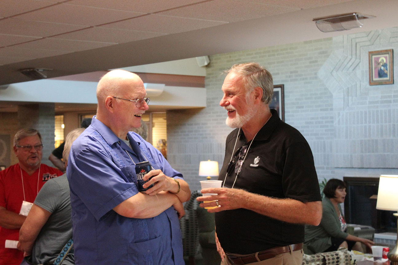 Fr. Phil Paxton, CP, and Paul Schulte share a laugh.