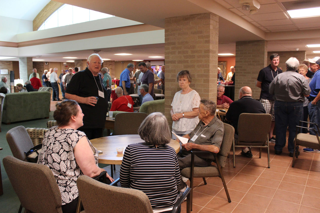 Fr. Bob Weiss, CP, Valerie and Frank Mullally chat with Tammy Drean and Susan Noltemeyer (backs to camera).