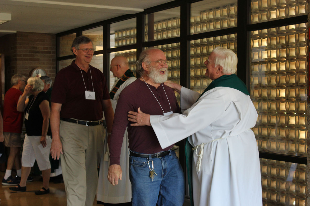Paul Della Mora shares a laugh with Fr. Bob Weiss, CP, after Mass.