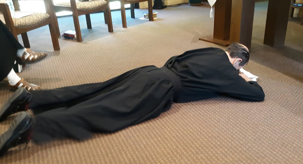 The Rite of Profession calls for Nicholas to lie prostrate as the Gospel of the Passion is read.