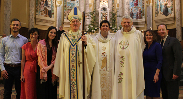 <em>(l-r): Phllip’s brother-in-law, Manu Fernández; sisters Cara Donlan-Fernández and<br>
Brenna Donlan; Bishop Neil Tiedemann, CP; Father Phillip Donlan, CP<br>
 Father Joe Moons, CP, Provincial of Holy Cross Province;<br>
and Phillip’s parents, Sue and Jerry Donlan.</em>
