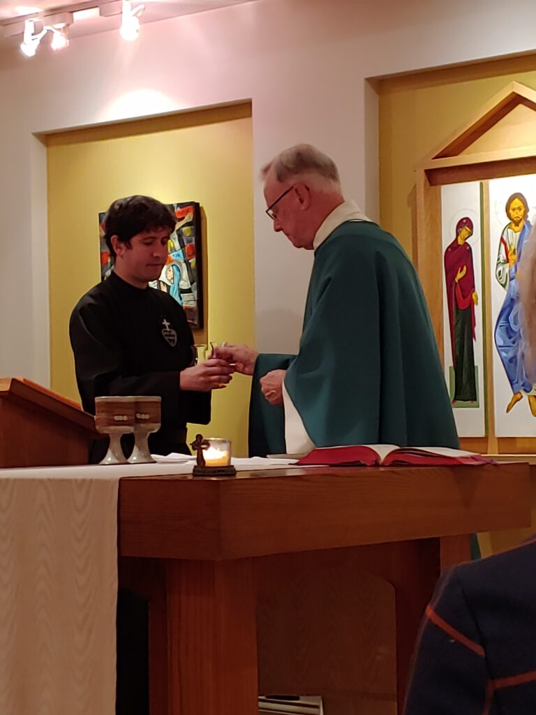 Celebrating community Mass at St. Vincent Strambi Community, assisted by Phillip Donlan, CP.