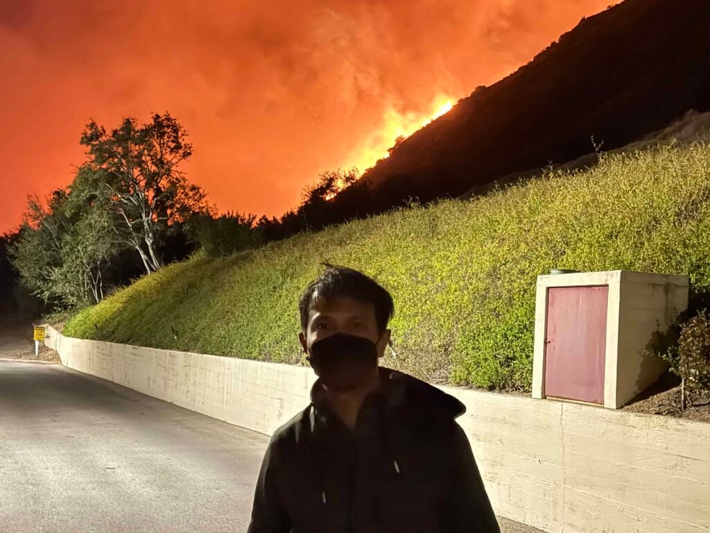 Fr. Febin Barose stands dangerously close to the Eaton fire outside the Mater Dolorosa Passionist Retreat Center
