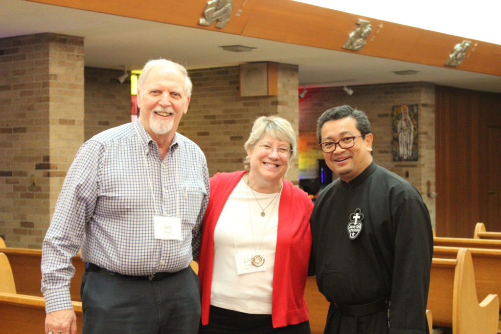A photo of Bill and Linda Berger with Fr. Enno Dango, CP, in the chapel at St. Paul of the Cross Retreat Center in Detroit as they attended the 2019 Passionist Alumni Reunion.