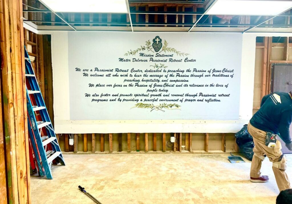 Workers repair parts of the Mater Dolorosa Retreat Center damaged by the Eaton wildire