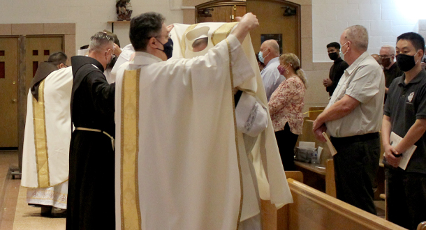 Nicholas is dressed in the deacon's vestments by Fr. Alfredo Ocampo, CP