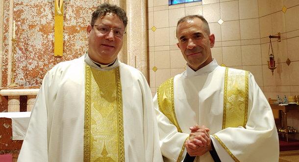 A photo of Fr. Alfredo Ocampo, CP, and Nicholas Divine, CP, in traditional white and gold vestments