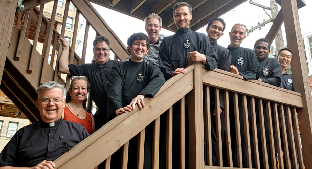 Members of the St. Vincent Strambi community posing for a photo on a staircase