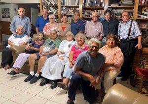 Large group of smiling people with a Passionist priest