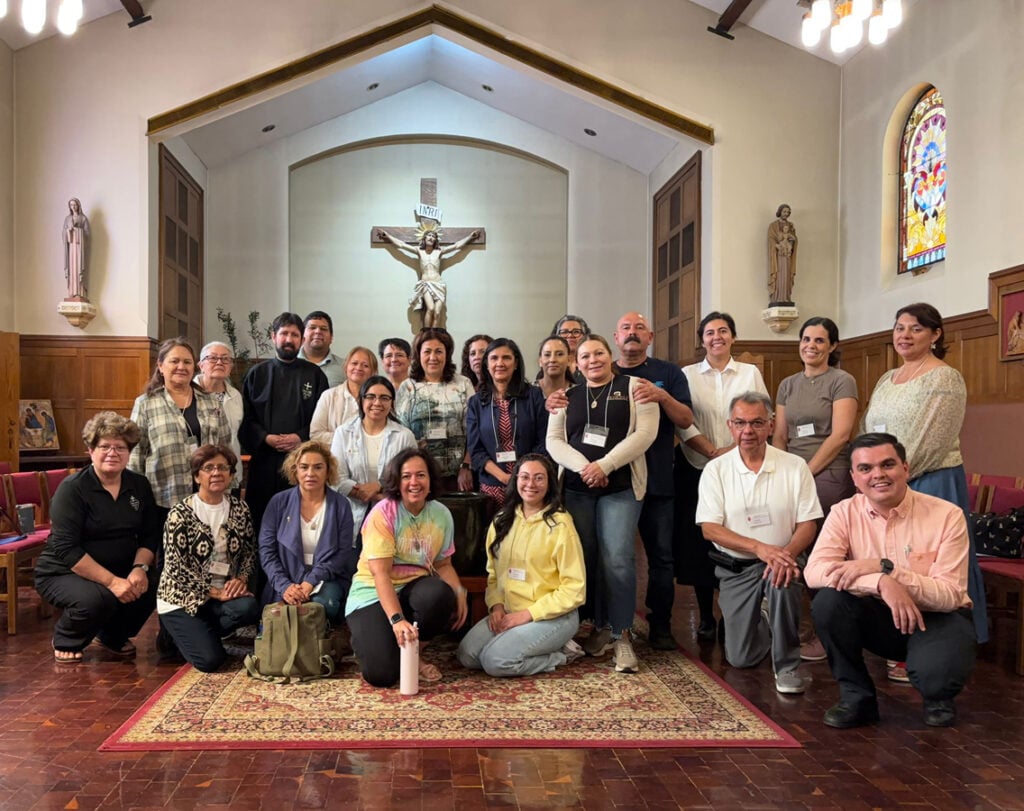 A group of folks pose in the chapel of Christ the King Retreat Center in Citrus Heights, CA, after a hispanic retreat.