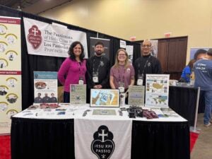 4 smiling people in an exhibition booth for the Passionists at the SEEK 2026 Conference