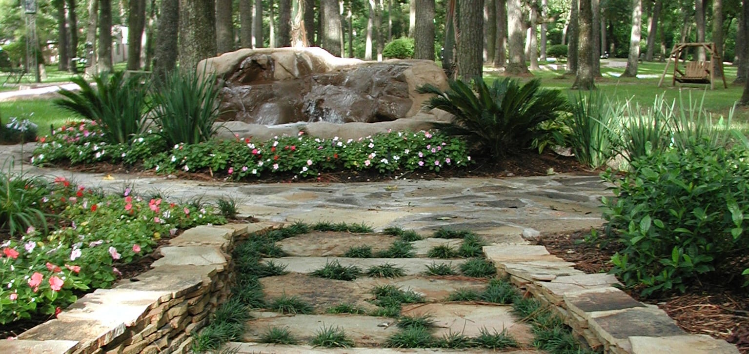Peaceful scene with Mary statue surrounded by trees and greenery at Holy Name Passionist Retreat Center in Houston, TX