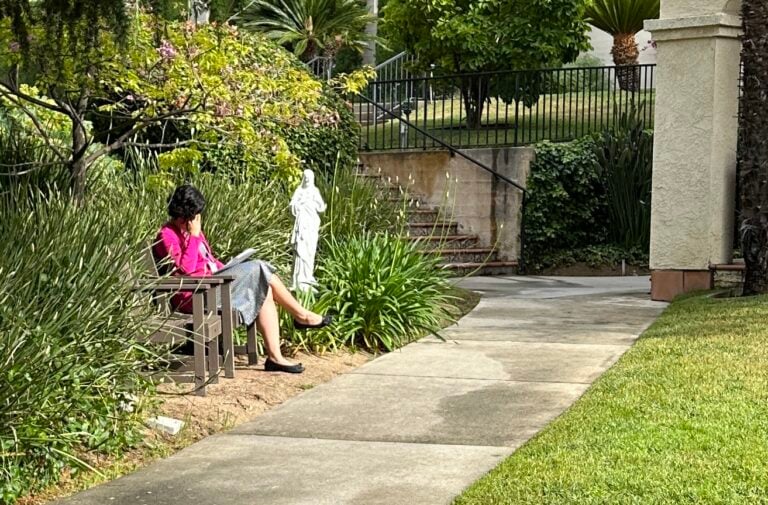 a women sits quietly in thought and reflection at a peaceful retreat center
