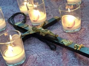 crucifix on a table surrounded by candles